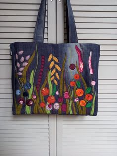 a hand painted bag hanging on the side of a door