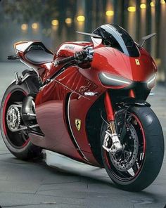 a red and black motorcycle parked on the street