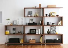 a room with some shelves and pictures on the wall above it, along with other items