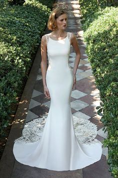 a woman in a white dress standing on a walkway