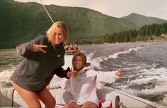 two women on a boat posing for the camera