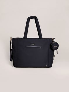 a black handbag on a white background with the handle hanging down and it's zippered pocket open