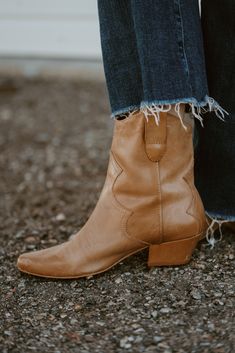 The prettiest pair of boots you'll ever own! And there's no zipper to worry about, because this boot works for everyone! Updated pull-on Western bootie with subtle stitch detailing. Please note that the leather used on this boot will age and distress with wear. Details: Leather upper. Manmade outsole. 7 in / 17.78 cm shaft height. 10 in / 25.4 cm boot opening. 2 in / 5.1 cm heel. Textile lining. Padded insole. Pull-on style. Imported. Fits true to size. Please note: due to the nature of the leat Leather Lined Ankle Moto Boots For Fall, Rugged Snip Toe Heeled Boots For Fall, Fall Boots With Heel Pull Tab And Medium Width, Fall Ankle Heeled Boots With Heel Pull Tab, Heeled Ankle Boots With Heel Pull Tab For Fall, Rugged Heeled Boots For Fall, Ankle Heeled Boots With Heel Pull Tab For Fall, Ranch Boots For Fall With Round Toe, Winter Ranch Moto Ankle Boots