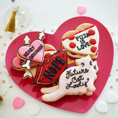 decorated cookies in the shape of hearts on a table