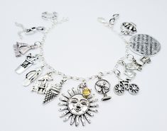 "For the love of Summer ☀️ This charm bracelet is a special find for all the summertime lovers out there. It features a collection of (15 antique silver charms) on a 3.5 mm sterling silver. 925 rolo bracelet chain. The charms on the bracelet represents some of the excitements of the season of summer.  The charms on this bracelet are: the sun, flip flop, crab, picnic basket, bicycle, umbrella chairs, sunglasses, cocktail drink, ice cream cone, fan, sail boat, shorts, moped, girl running, and a di Friendship Themed Charm Bracelet, Symbolic Bracelet Charms For Gifts, Symbolic Charms For Bracelets As Gifts, Sterling Silver Bracelets With Vintage Charm For Gift, Sterling Silver Bracelets With Vintage Charm As A Gift, Symbolic Bracelet Charms As Gifts, Symbolic Vintage Charm Bracelet For Gift, Silver Themed Bracelets For Friendship, Sterling Silver Charm Bracelet For Friendship With Lobster Clasp