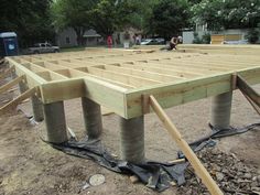 some pipes are laying on the ground in order to be used as an extension for a house