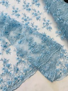 Light Blue Lace Fabric, Blue Lace Dress With Floral Applique, Blue Lace Dresses With Floral Applique, Fitted Blue Fabric With Floral Embroidery, Fitted Blue Embroidered Fabric With Floral Design, Fitted Blue Floral Embroidered Fabric, Lace Embroidered Fabric With Floral Applique For Parties, Blue Organza Embroidered Fabric For Party, Fitted Floral Embroidered Net Dress