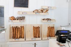 breads and pastries are displayed in wooden boxes