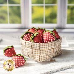 three strawberries in a basket on a table near a window with the sun shining