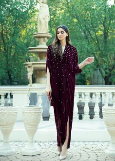 Burgundy Velvet Kaftan delicately handworked with dainty flowerets in pearls, beads, and sequence Pakistani Kaftan Designs, Velvet Dress Designs Pakistani, Pakistani Kaftan, Velvet Kaftan Dress, Velvet Abaya, Velvet Kaftan, Kebaya Wedding, Wedding Trousseau, Heavy Dresses