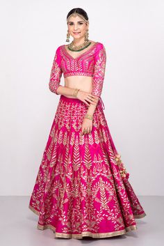 This gotta patti lehenga set features a pink blouse fabricated in pure raw silk with a matching pink lehenga. The entire lehenga set is filled with flawless zari and gotta patti work in floral patterns. It also has a net dual pink dupatta that matches the entire set. Both the dupatta corners and the lehenga bottom have a silver border that perfectly complements the pink coloured lehenga set. Pink Choli Design, Pink Raw Silk Sharara For Festivals, Pink Raw Silk Sharara With Gota Work, Pink Raw Silk Sharara For Navratri, Pink Raw Silk Set With Zari Work, Pink Raw Silk Anarkali Set For Navratri, Pink Lehenga With Dori Work In Raw Silk, Pink Raw Silk Lehenga For Navratri, Pink Raw Silk Lehenga With Dori Work