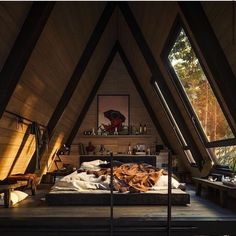 an attic bedroom with wooden walls and flooring