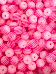 many pink donuts are in a white bowl