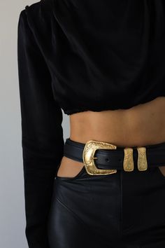 Add a vintage touch to your look with this western-inspired belt featured in black Italian leather, an eye-catching gold buckle, engraved details, and a metal tip. Feather Edge Adjustable Fit 1.5" Genuine Italian Leather Ethically Made in California Gold Western Belt, Black Belt With Gold Buckle, Gold Leather Belt For Fall, Chic Black Belt Buckles With Brass Detail, Chic Black Belt Buckles With Brass Buckle, Gold Western Belt Buckles For Formal Wear, Gold Western Belt Buckles For Formal Occasion, Chic Formal Antique Belt Buckle, Elegant Gold Belt For Fall