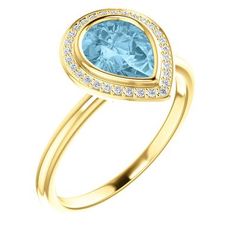 a gold ring with blue topazte and diamonds