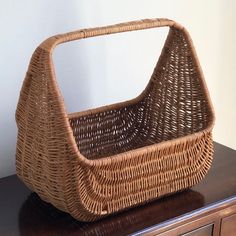 a wicker basket sitting on top of a wooden dresser