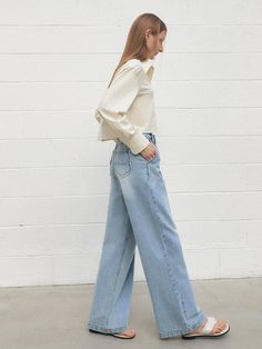 This product features a pair of one-tuck wide Dolingo denim pants that marry comfort with a touch of retro flair. The wide-leg design and high waist create a flattering silhouette and a relaxed vibe. With their single tuck detail, these jeans provide a subtle nod to classic tailoring while remaining effortlessly modern. - The pants are tailored with a wide-leg design and a high waist, offering a vintage-inspired yet contemporary look.- A handmade Cali medal decoration has been attached to the lower right side of the front panel to add a unique point of interest.- The one tuck at the front adds structure and style to the otherwise fluid design.- Constructed from denim, these pants are durable and versatile, ideal for various casual and semi-casual settings. Chic Denim Blue Wide-leg Flare Jeans, Spring High-waisted Relaxed Fit Flare Jeans, Light Wash Wide Leg Flare Jeans For Work, Wide Leg Light Wash Flare Jeans For Work, Retro Wide Leg Jeans With Relaxed Fit, Chic Medium Wash Wide Leg Pants For Fall, Classic Denim Wide Leg Pants For Spring, Spring Light Wash Wide-leg Flare Jeans, Chic Light Wash Wide Leg Flare Jeans