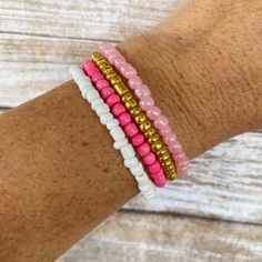 ♥ This pink seed bead stack bracelet set will level up your style and make your outfit pop! Wear one as a statement piece or the whole stack! These are so trendy right now! ♥ These are perfect for: ~ Stacking with other bracelets ~ Gifts for all ages ~ Party Favors or Stocking Stuffers ~ Beachwear/Pool wear ♥ This listing includes the set of 4 bracelets shown. You can choose between the gold set, or the silver set in the drop-down menu. To purchase multiple sets, adjust the quantity at checkout. These beaded bracelets are made with 6/0 seed beads. They are strung together with elastic which is stretchy.  ♥ CUSTOMIZATION: These are customizable! Just send us a message about what colors or theme you would like, and we will discuss customization options. Otherwise, bracelets will come as show Adjustable Pink Friendship Bracelets With Spacer Beads, Stackable Pink Beaded Bracelets, Pink Stackable Heishi Beads Stretch Bracelet, Pink Heishi Beads Stretch Bracelet Stackable, Stackable Pink Beaded Bracelets With Round Beads, Pink Stackable Heishi Beads Bracelets, Pink Stackable Beaded Bracelets With Round Beads, Pink Stackable Beaded Bracelets, Pink Stretch Bracelet With Tiny Beads