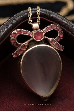 This Georgian locket s fashioned is fashioned in the shape of a heart surmounted by a bow set with flat cut garnets. The locket fittings tests as 10k gold. Hangs from a new 14k gold chain. We offer antique jewelry sourced with the utmost care. All of our jewelry is one-of-a-kind, check out our collection today! Hair Locket, Heart Wedding Rings, Key Bracelet, Garnet Heart, Crescent Earrings, Antique Locket, Diamond Crown, Head Ring, Enamel Necklaces