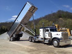 a large truck with a ramp attached to it's back