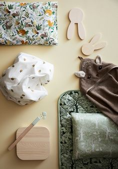 the baby's toys are laid out on the wall next to the blanket and other items