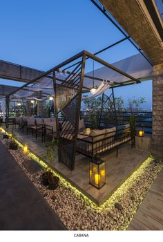 an outdoor seating area with candles and lights