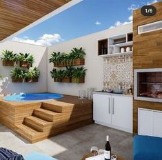 a living room with a hot tub next to a fire place and potted plants on the wall