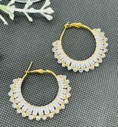 "This beadwork project is a pair of lovely  hoop white and gold plated earrings. They measure about 1.75\" long from the top of the ear wire to the bottom beads.  These were designed and beaded be me in my smoke free studio." Beaded Small Hoop Earrings In Metal, Small Hoop Beaded Metal Earrings, Gold Beaded Hoop Earrings For Party, Gold Hoop Earrings With Beads For Party, Metal Hoop Beaded Earrings, Metal Hoop Beaded Earrings For Pierced Ears, Beaded Metal Hoop Earrings, Beaded Metal Small Hoop Earrings, Small Beaded Metal Hoop Earrings