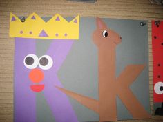 paper cut out of the letter k and a deer with a crown