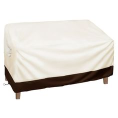 a white and brown ottoman cover on top of a wooden table