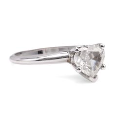 an engagement ring with a pear shaped diamond