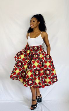 "Go dancing in this fun Side Belted Umbrella Skirt with Pockets!  This piece is fastened with an elastic waistband and fits size Small to Large. Model is a size medium and 5'6\" tall. Length: 25\" Material: 100% Cotton Ankara Fabric. Free size customization available." Skirt African Print, Umbrella Skirt, Handmade Skirts, Beautiful Kimonos, Ankara Fabric, Skirt With Pockets, Circle Skirt, Skirts With Pockets, African Print