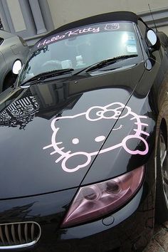 a car with hello kitty decals on the hood