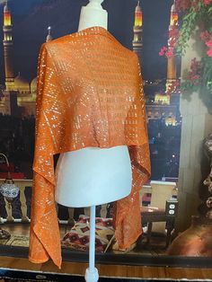 Gorgeous Orange VINTAGE  Egyptian Assuit ! This beauty has thick strong tulle that reflects the shiniest silver motifs on this delicious shawl with beaded braided ends.   That gives it the perfect weight to wear. This beauty came from a collector in France with an exquisite taste for fashion. The shawl is 75 inches long and approx. 16 inches wide. There are brilliant silver classic Egyptian motifs that you can't escape talking about as everyone will be interested as you walk into an event or room   This is so elegant and beautiful in person, don't let it pass you by. The tulle is heavier than the cotton-linen ones, and not as soft. *Overseas / Worldwide shipping available. Please reach out Orange Shawl, Egyptian Motifs, Egyptian Revival, Shiny Silver, Shawls And Wraps, Cotton Linen, Scarf Wrap, Scarf Accessory, Shawl