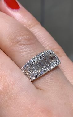 a woman's hand with a diamond ring on it