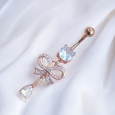 Super cute y2k 2000s rose gold diamond rhinestone ribbon bow heart dangling belly piercing ring bar.  Surgical steel  FREE STANDARD UK SHIPPING Elegant Body Jewelry With Bling For Gifts, Elegant Gold Belly Rings, Trendy Bling Jewelry As A Gift, Trendy Rose Gold Cubic Zirconia Jewelry, Dangle Metal Belly Rings, Elegant Gold Belly Rings Gift, Elegant Metal Dangle Belly Rings, Dangle Belly Rings For Wedding, Elegant Cubic Zirconia Belly Rings As Gift