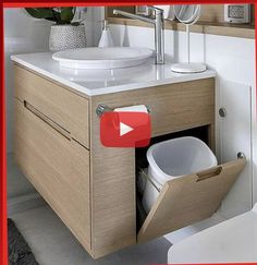 a white toilet sitting next to a bathroom sink under a mirror with a red frame