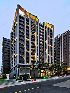 an apartment building lit up at night on the street