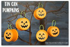 four pumpkins hanging from a tree with the words tin can pumpkins on them