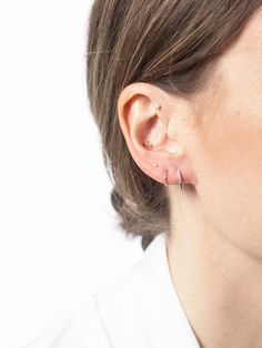 a close up of a person wearing some kind of ear piercing on their left ear