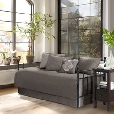 a living room with a couch, table and window in it's center area