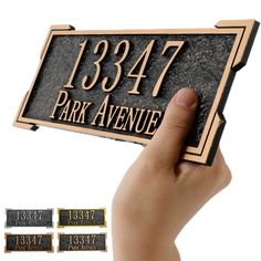 a hand holding up a plaque that says, 1387 park avenue