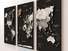 three black and white maps hanging on the wall with gold foil accents, each showing different countries