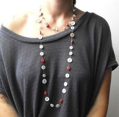 a woman wearing a necklace with buttons on it