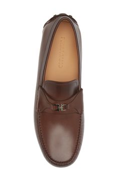 A mini double-Gancio bit tops the strap of this sophisticated take on a driving loafer crafted of calfskin with a hand-sewn sole covered with custom tread. Removable insole Leather upper and lining/leather and rubber sole Made in Italy Men's Designer Shoes Mens Designer Shoes, Driving Loafers, Cocoa Brown, Salvatore Ferragamo, Loafers Men, Hand Sewn, Designer Shoes, Calf Skin, Hand Sewing