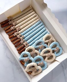 an open box filled with lots of doughnuts and pretzels on top of each other