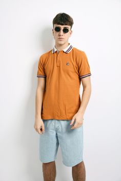 "FILA vintage polo shirt men's in orange. Size - US XS, UK/F/I S, D 48. Model is 180 cm / 5ft 11\" tall and usually wears size M. Very good vintage condition. Flat measurements: Length - 26.3\" / 67 cm; Pit to pit (chest) - 19.3\" / 49 cm. All orders are shipped every day Worldwide from EU. Safe registered standard delivery Worldwide with courier and tracking number. Free delivery from €80/$92! We are also sending with very fast Express delivery (UPS). Just choose shipping upgrade in your cart. Sporty Polo Collar T-shirt For Summer, Retro Collared T-shirt For Streetwear, Sporty Collared Polo Shirt For Streetwear, Summer Streetwear Polo Collar Top, Summer Polo Collar Top For Streetwear, Sporty Cotton Polo Shirt For Summer, Brown Cotton Polo Shirt For Summer, Yellow Polo Shirt With Collar For Summer, Summer Polo Collar T-shirt For Streetwear