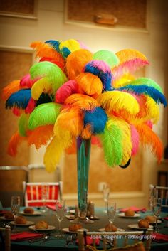 colorful feathers in a vase with the words ostrich feathers for wedding centerpieces