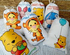 four winnie the pooh drawsacks are sitting next to each other on a bed