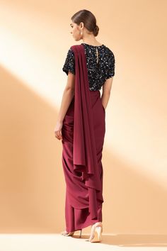 Maroon pre-draped saree with ruffle detail and pleated pallu. Comes with embroidered blouse.
Component: 2
Pattern: Embroidery
Type Of Work: Sequin
Neckline: Round
Sleeve Type: Half
Fabric: Moss Crepe
Color: Maroon
Other Details: 
Sequin embroidered blouse
Closure: Side zip
Occasion: Destination Wedding - Aza Fashions Festive Pre-draped Georgette Saree, Georgette Saree With Draped Sleeves For Evening, Party Georgette Saree With Draped Sleeves, Party Saree With Draped Sleeves In Georgette, Pre-draped Georgette Saree In Traditional Style, Georgette Pre-draped Saree With Cape Sleeves For Diwali, Traditional Georgette Pre-draped Saree With Draped Sleeves, Designer Georgette Saree With Draped Sleeves, Traditional Pre-draped Georgette Saree With Draped Sleeves